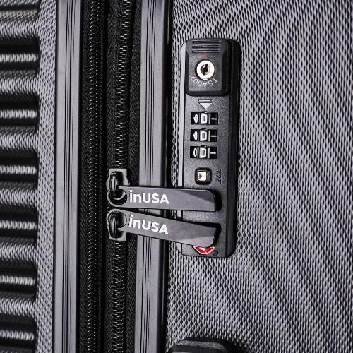 Close-up of a gray suitcase with a combination lock and 'inusa' branding.