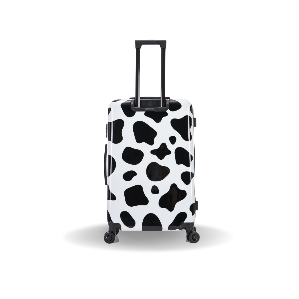 Black and white cow print suitcase on a white background