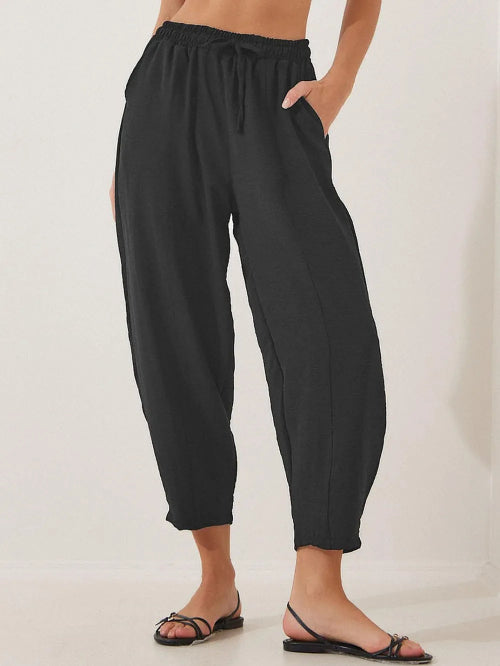 Black wide-leg pants worn by a person on a plain background