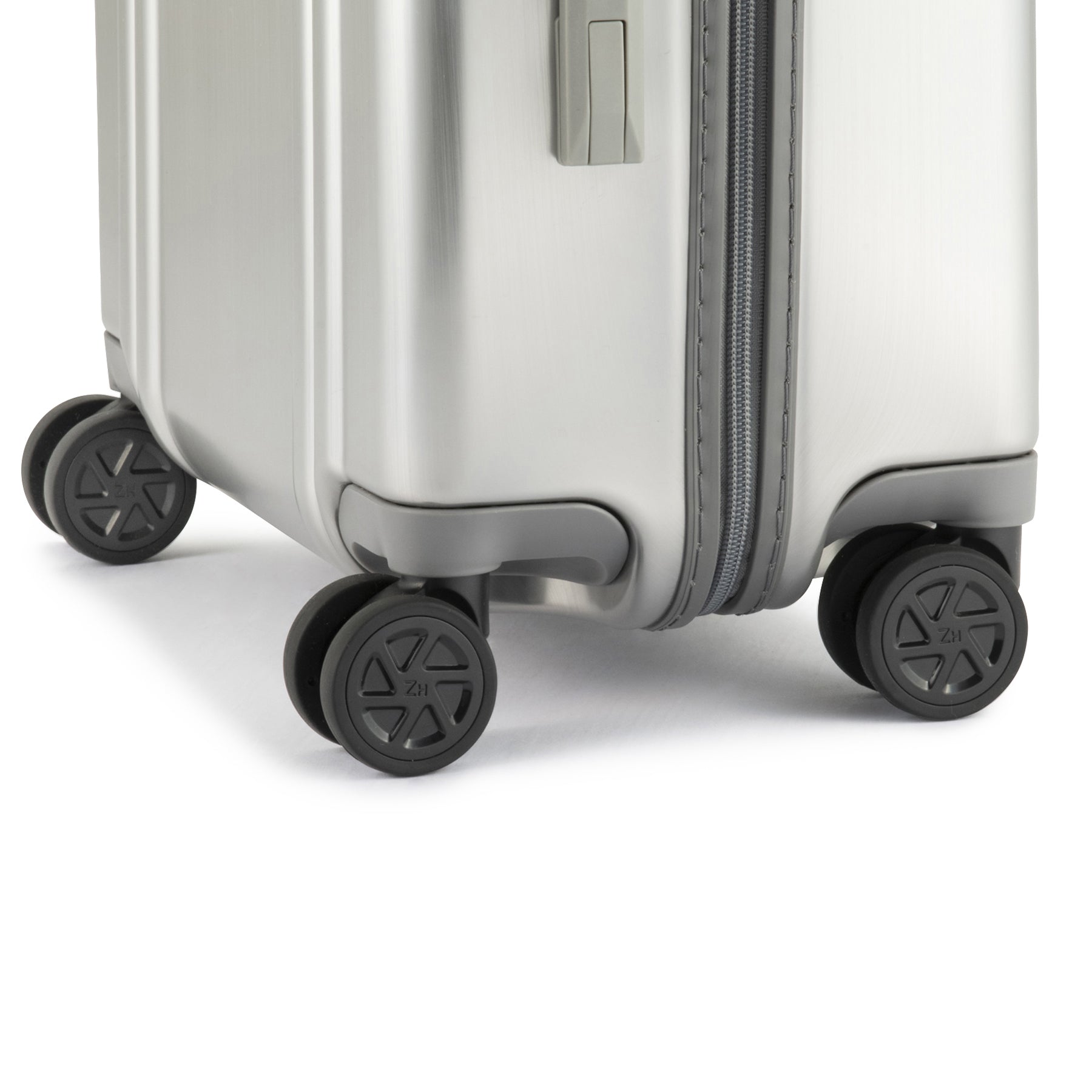Silver suitcase with wheels on a white background