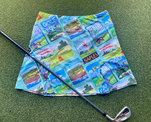 Golf-themed fabric with images of golf courses and a golf club on a green surface