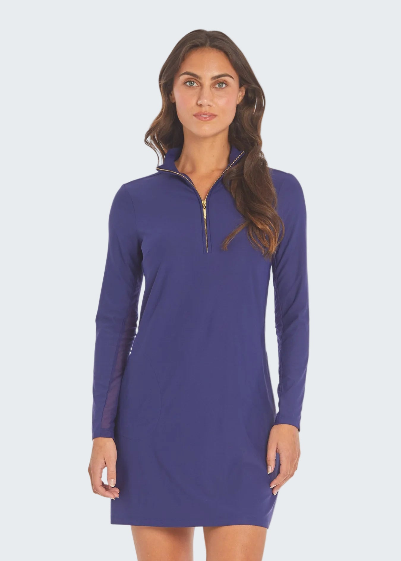 Woman wearing a purple long-sleeve dress with a quarter zip on a white background