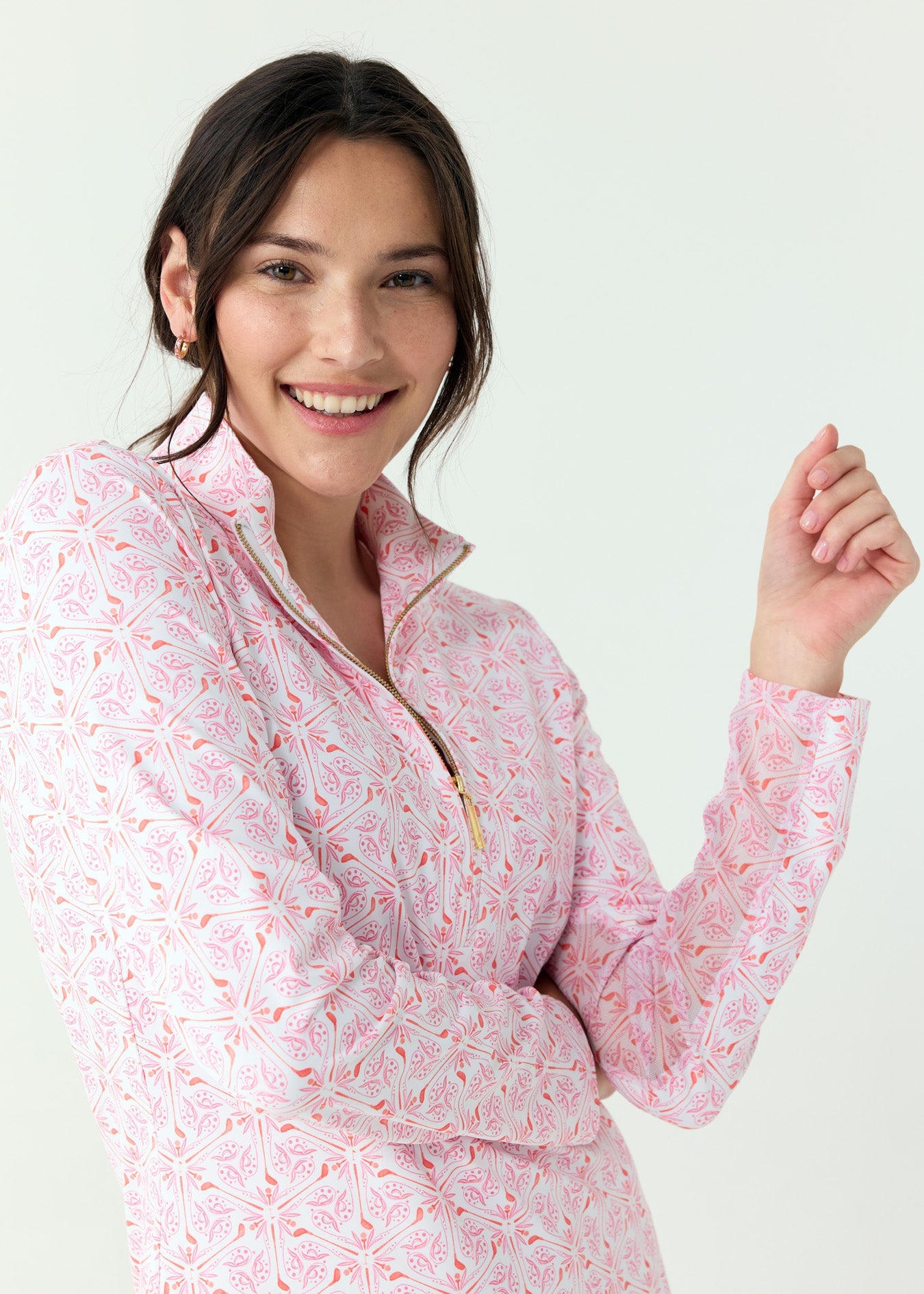 Woman wearing a pink floral patterned shirt on a white background