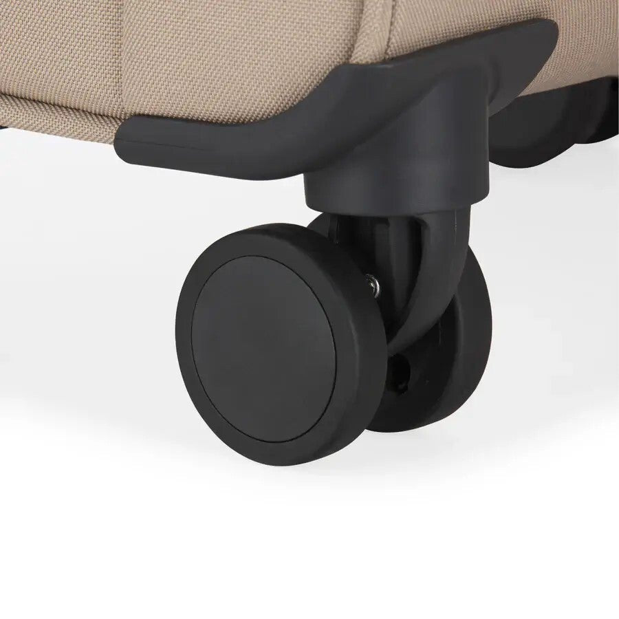 Close-up of a black caster wheel on a beige chair with a white background
