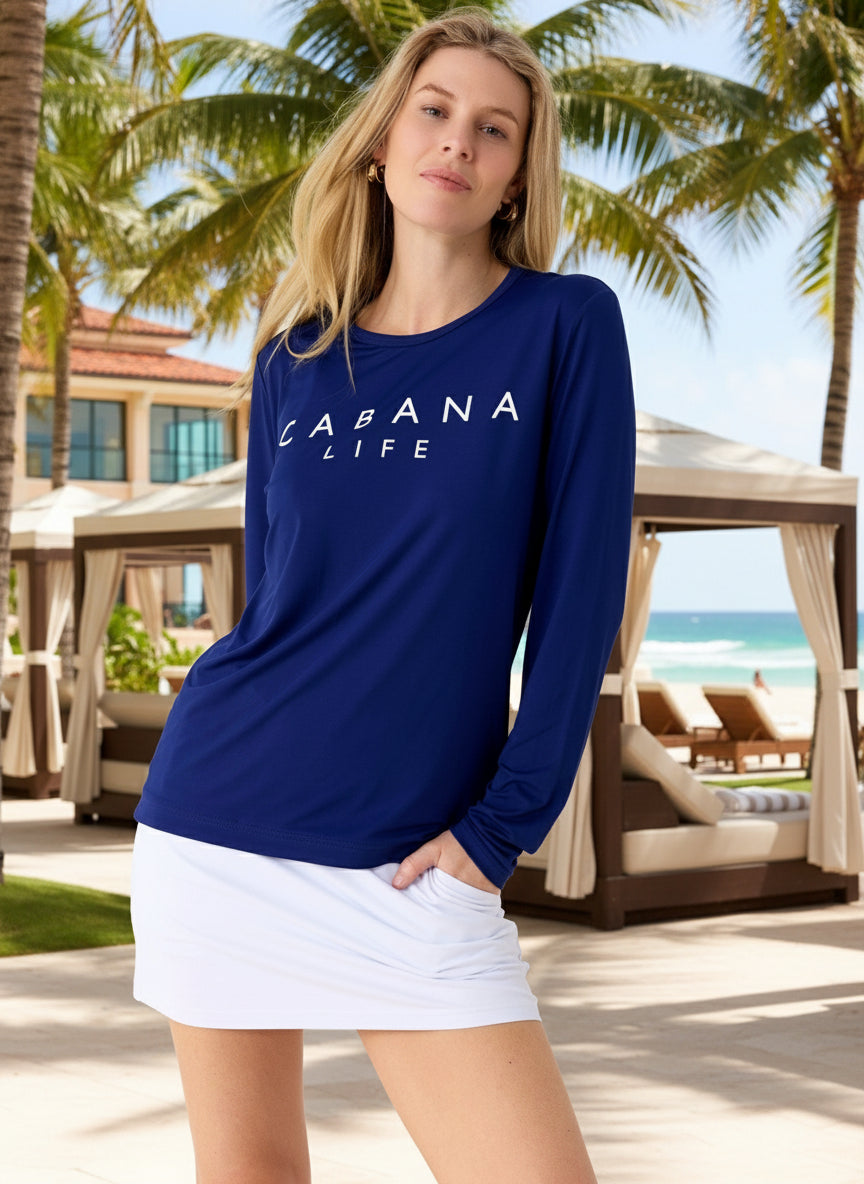 Woman wearing a navy blue 'Cabana Life' long-sleeve shirt against a white background