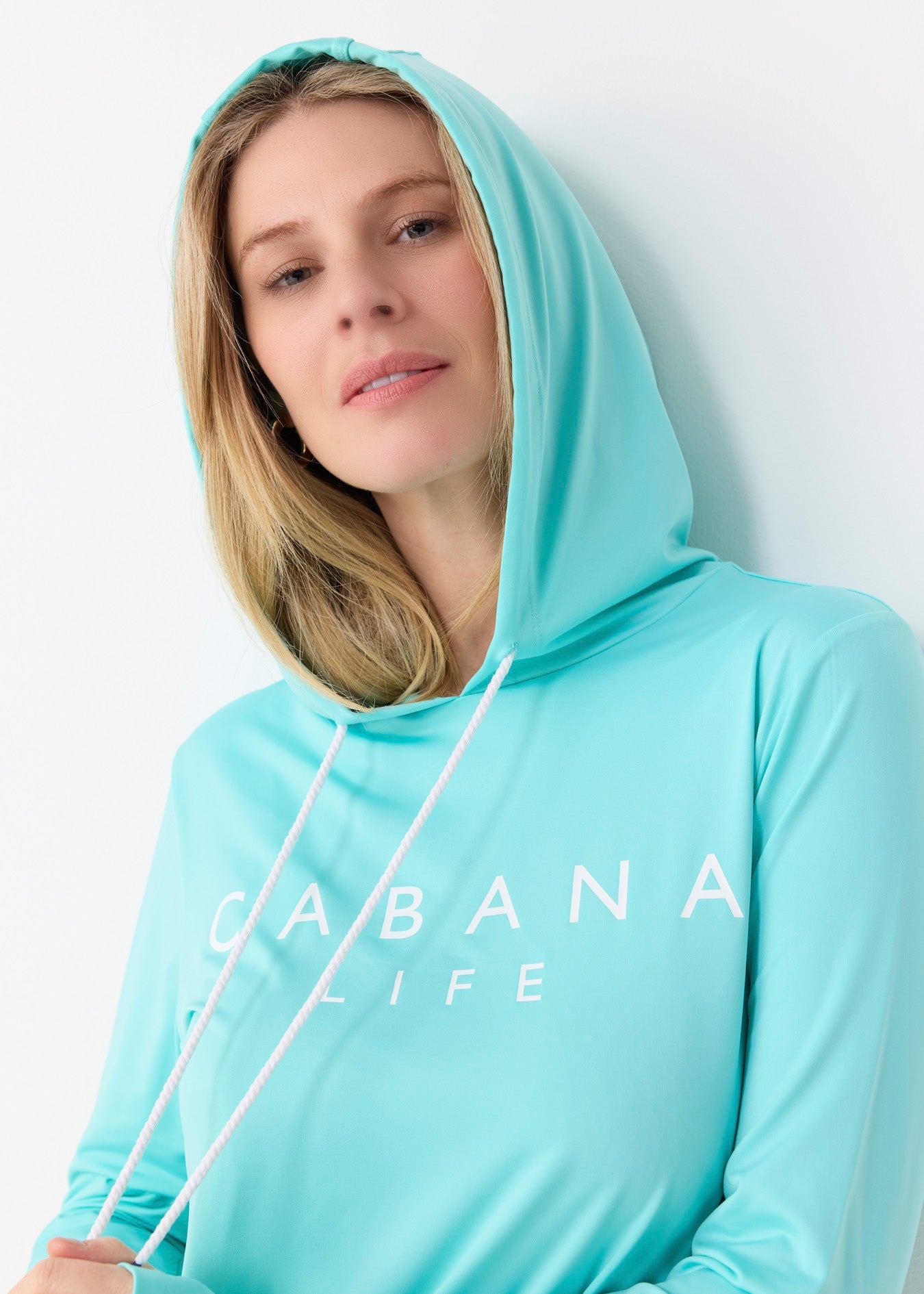 Person wearing a light blue hoodie with 'CABANA LIFE' text on a white background