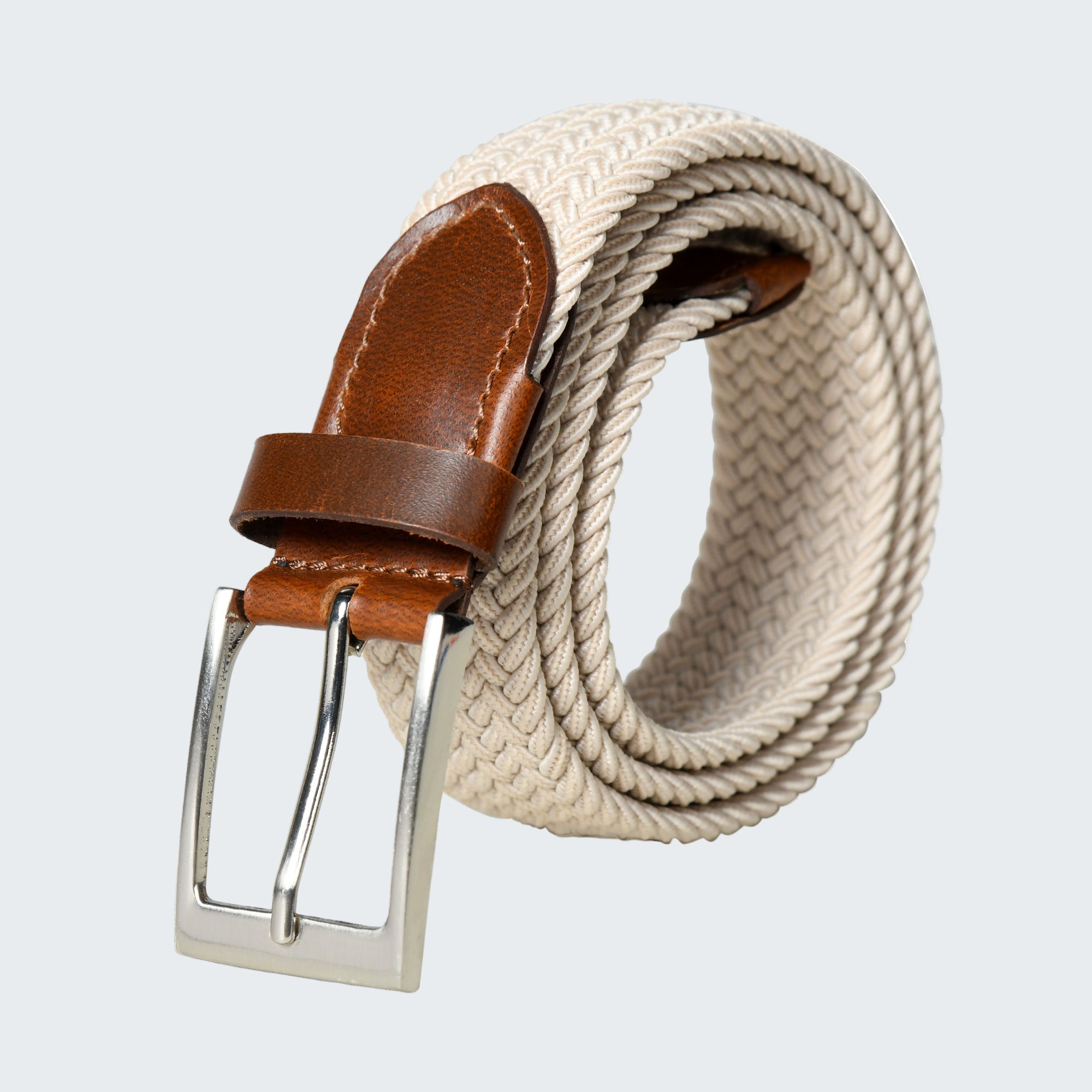 Beige woven belt with brown leather strap and silver buckle on a white background