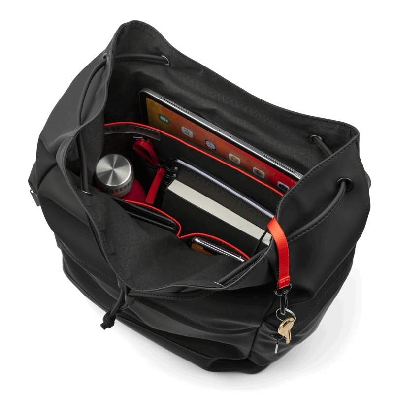 Black backpack with red interior and compartments on a white background