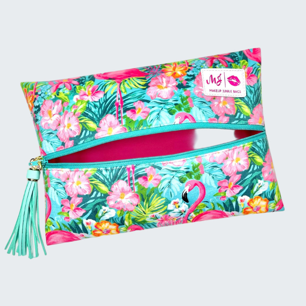 Makeup bag with flamingo and floral design on a white background