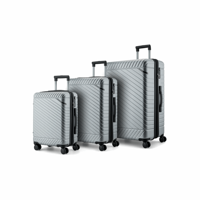 Set of three silver suitcases of different sizes on a white background