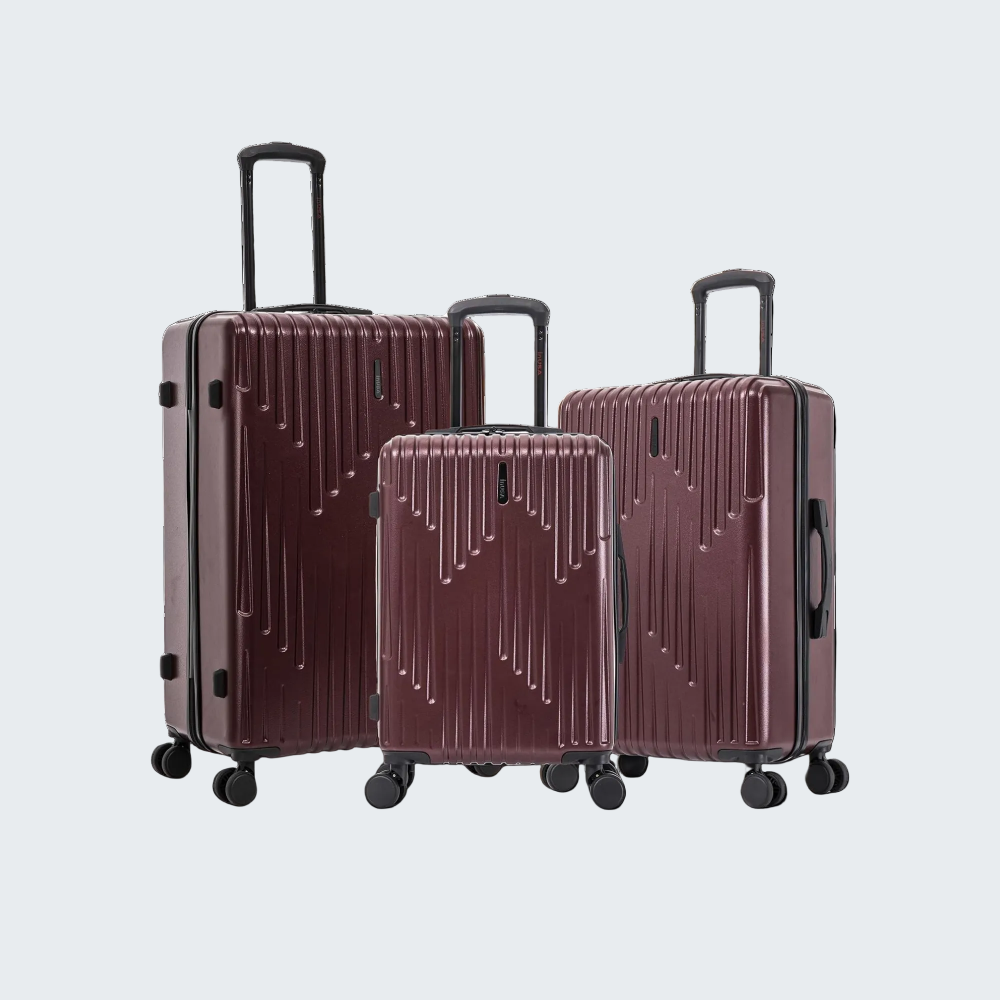 Set of three purple suitcases with black handles and wheels on a white background