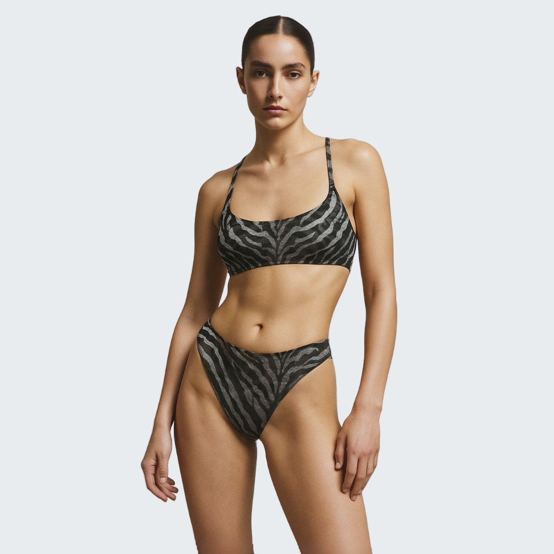 Woman wearing a black and white zebra print bikini against a gray background