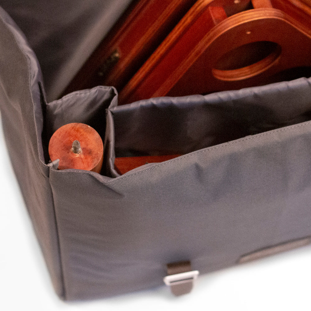 Gray bag with wooden items inside on a white background