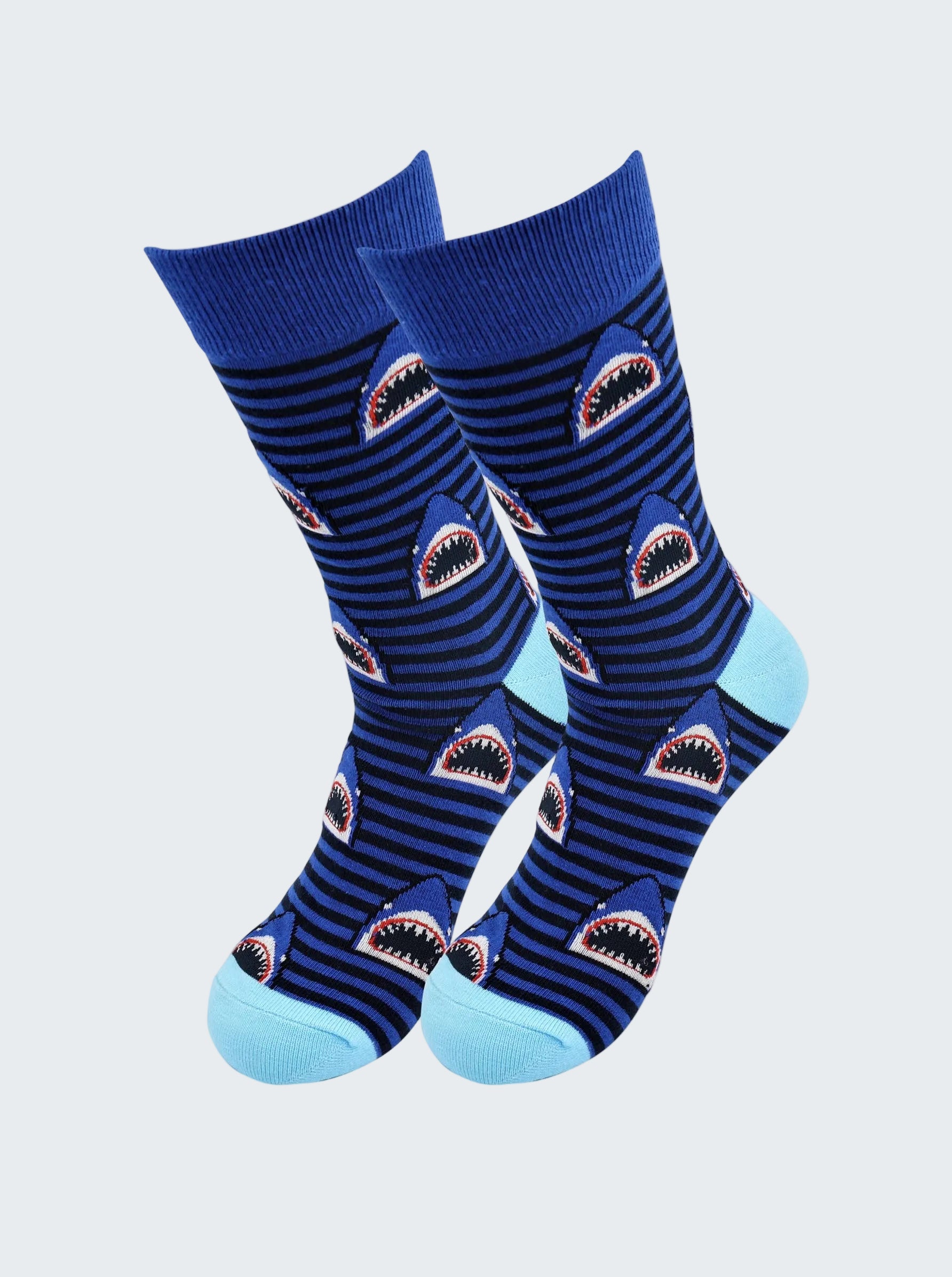 Pair of blue socks with shark design on a white background