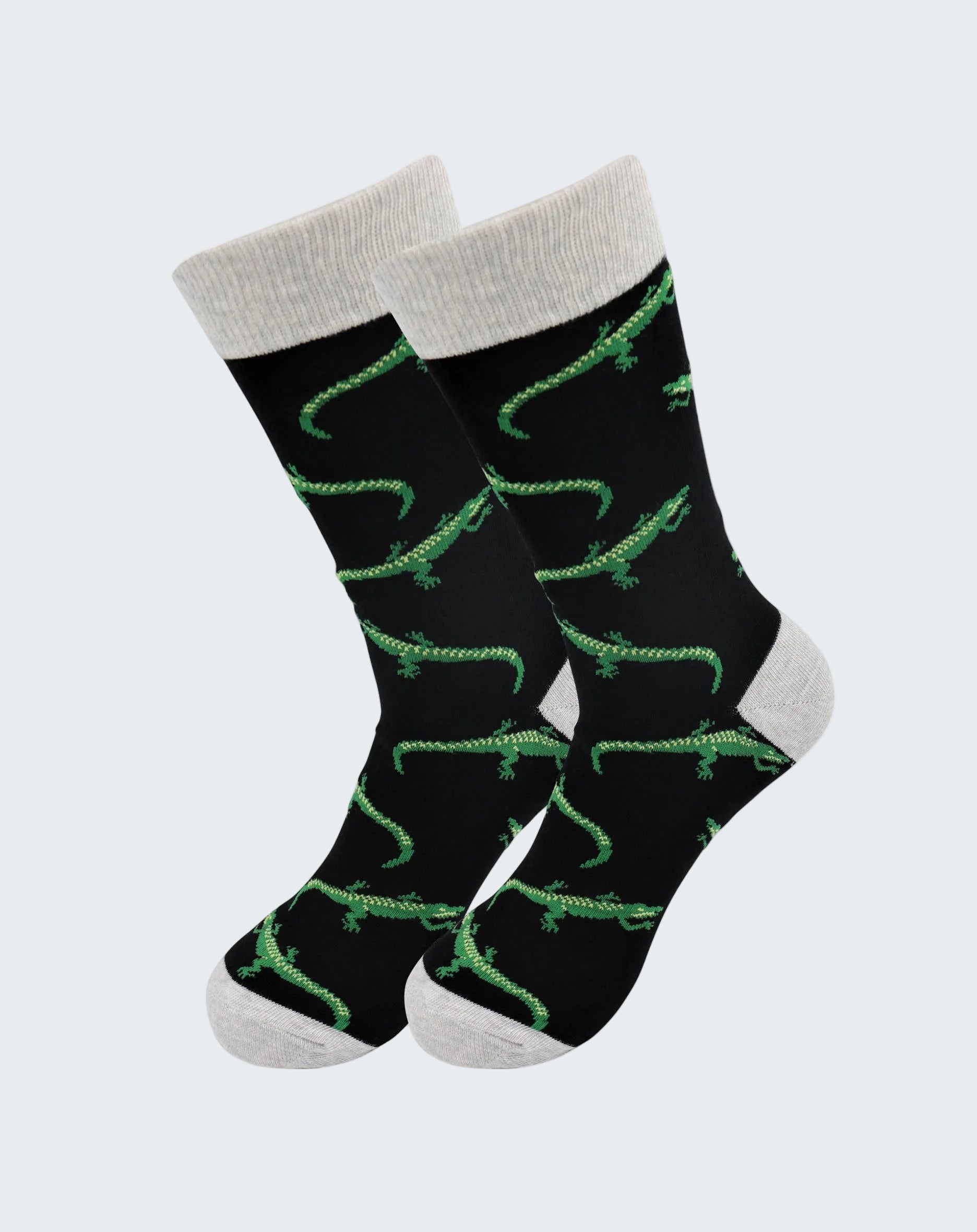 Black socks with green alligator pattern and gray cuffs and toes on a white background