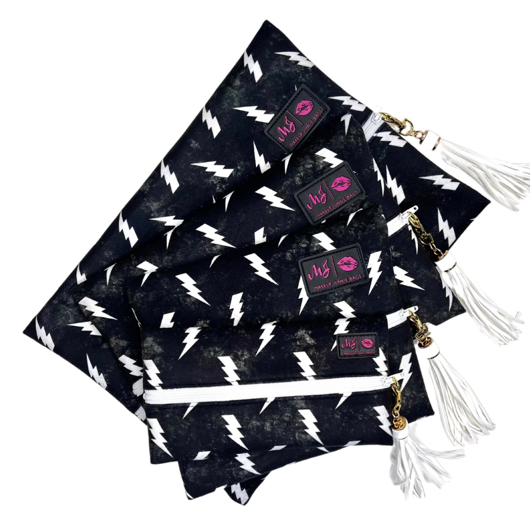 Black bags with white lightning bolt patterns and visible brand logos on a white background