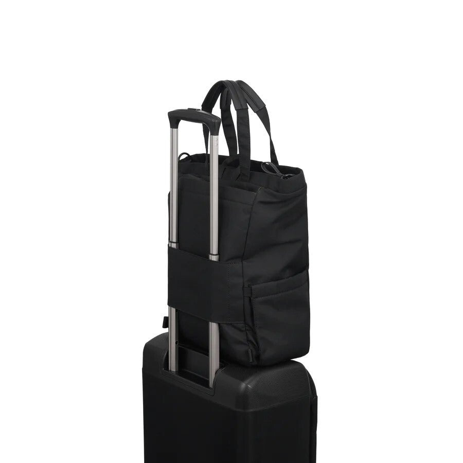 Black rolling bag stacked on a black suitcase against a white background