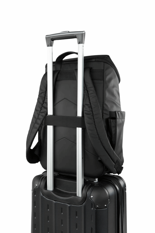 Black backpack on top of a black suitcase with a white background