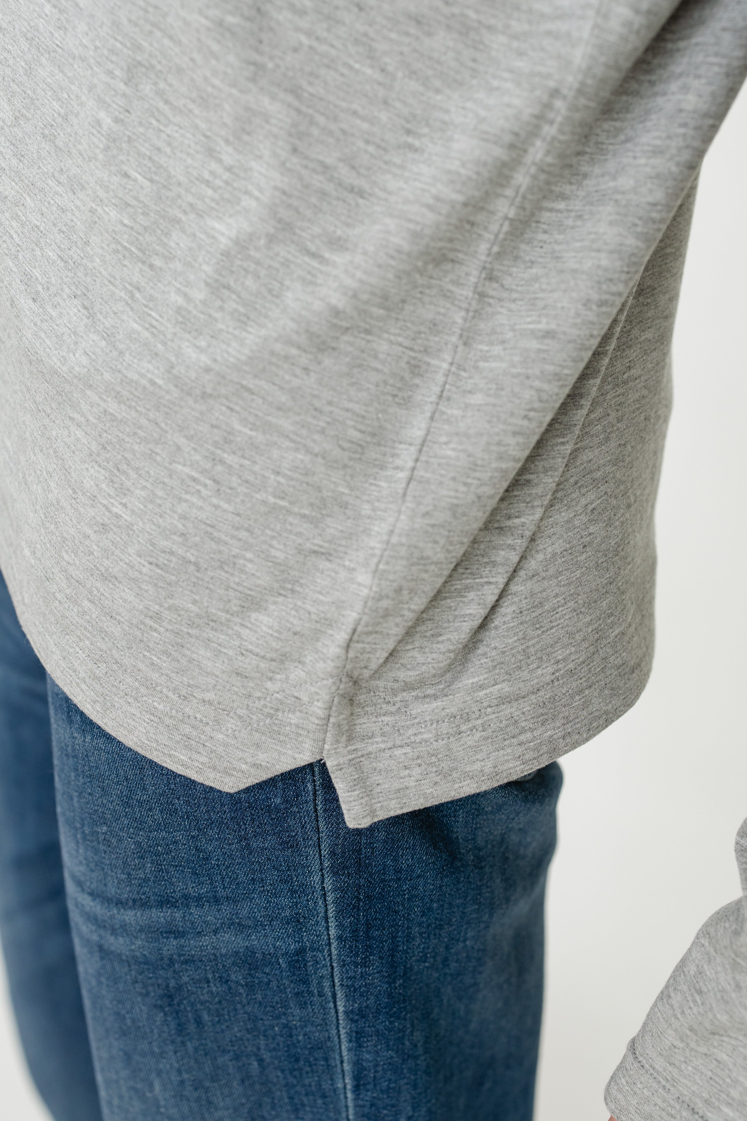 Gray sweatshirt and blue jeans on a white background