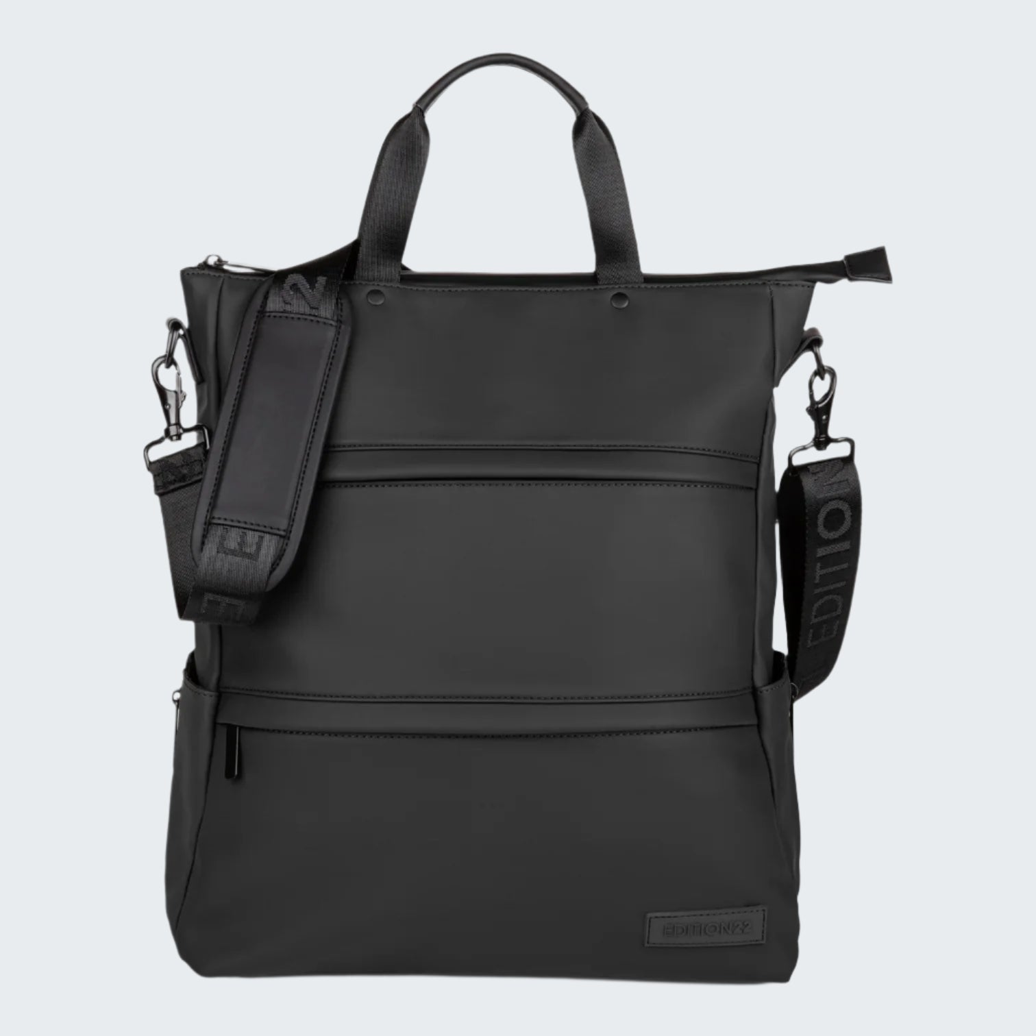 Black backpack with multiple compartments and straps on a white background