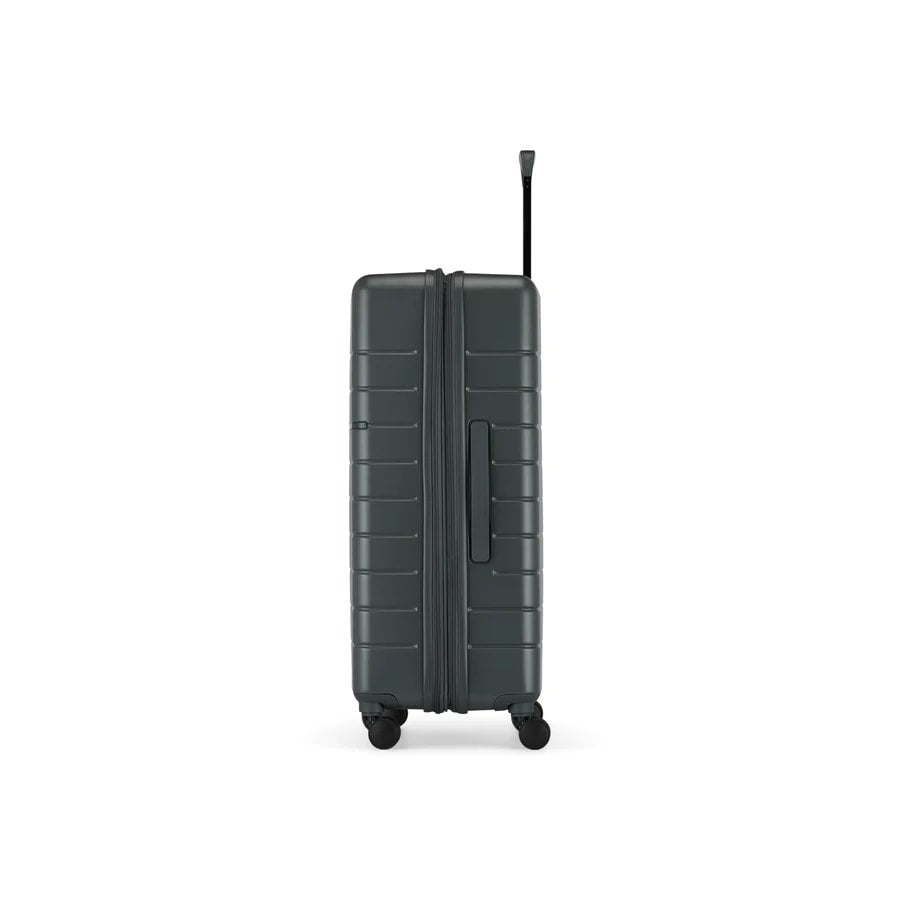 Green suitcase with wheels on a white background