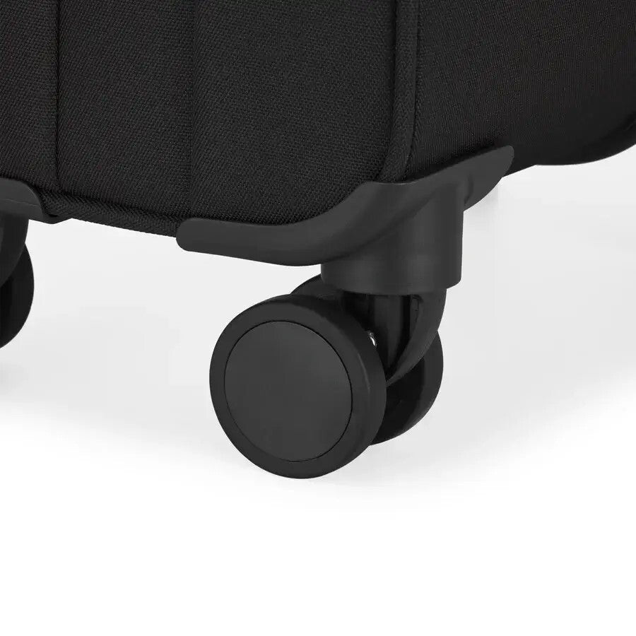 Close-up of a black suitcase wheel on a white background