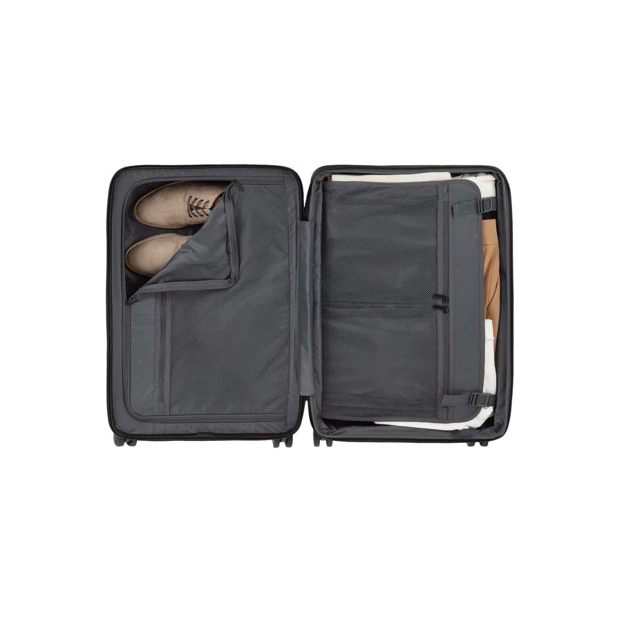 Open suitcase with a shoe compartment on a white background