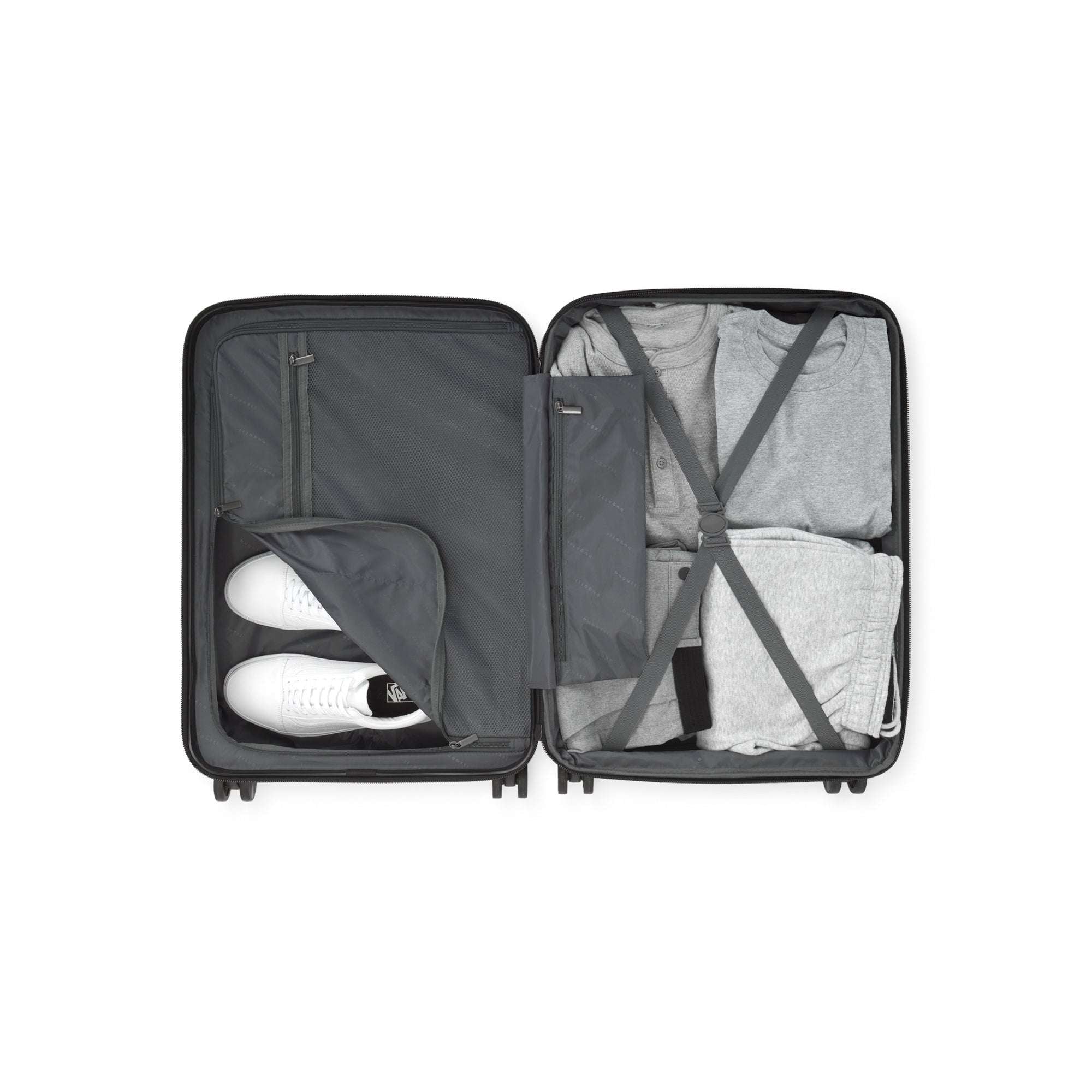 Open suitcase with clothes and shoes on a white background