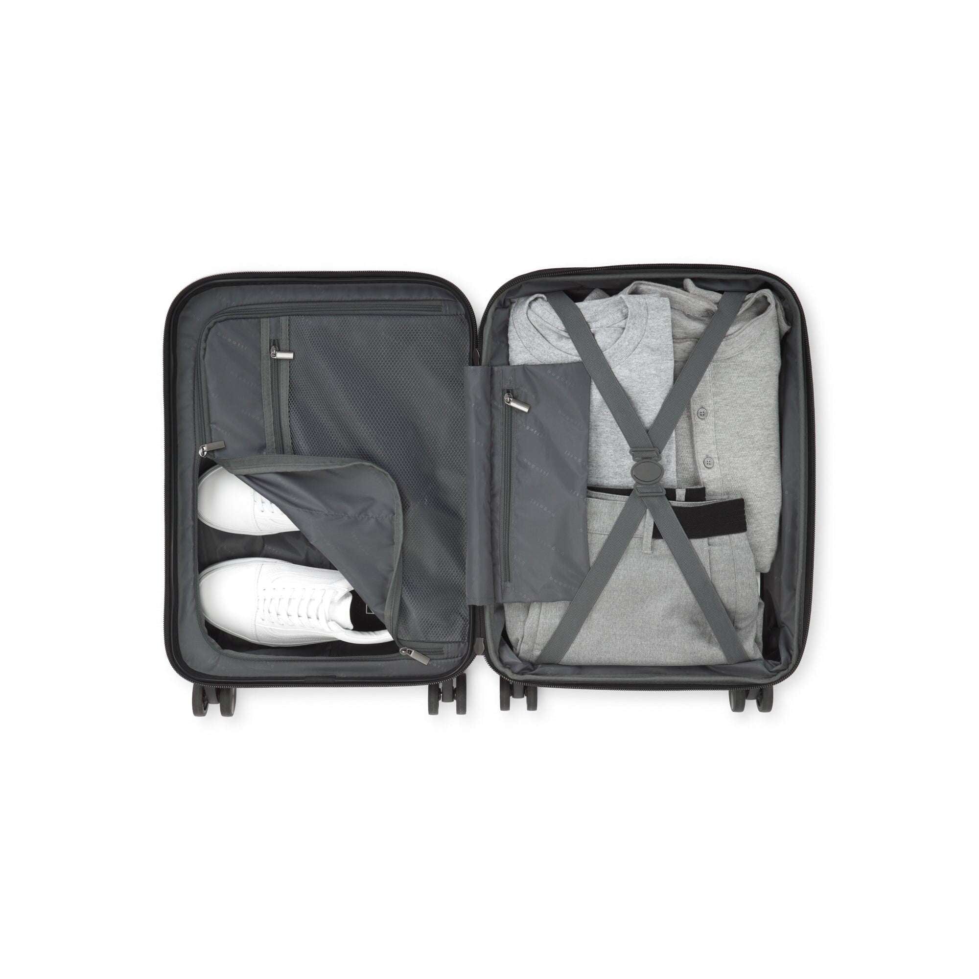 Open suitcase with clothes and shoes on a white background
