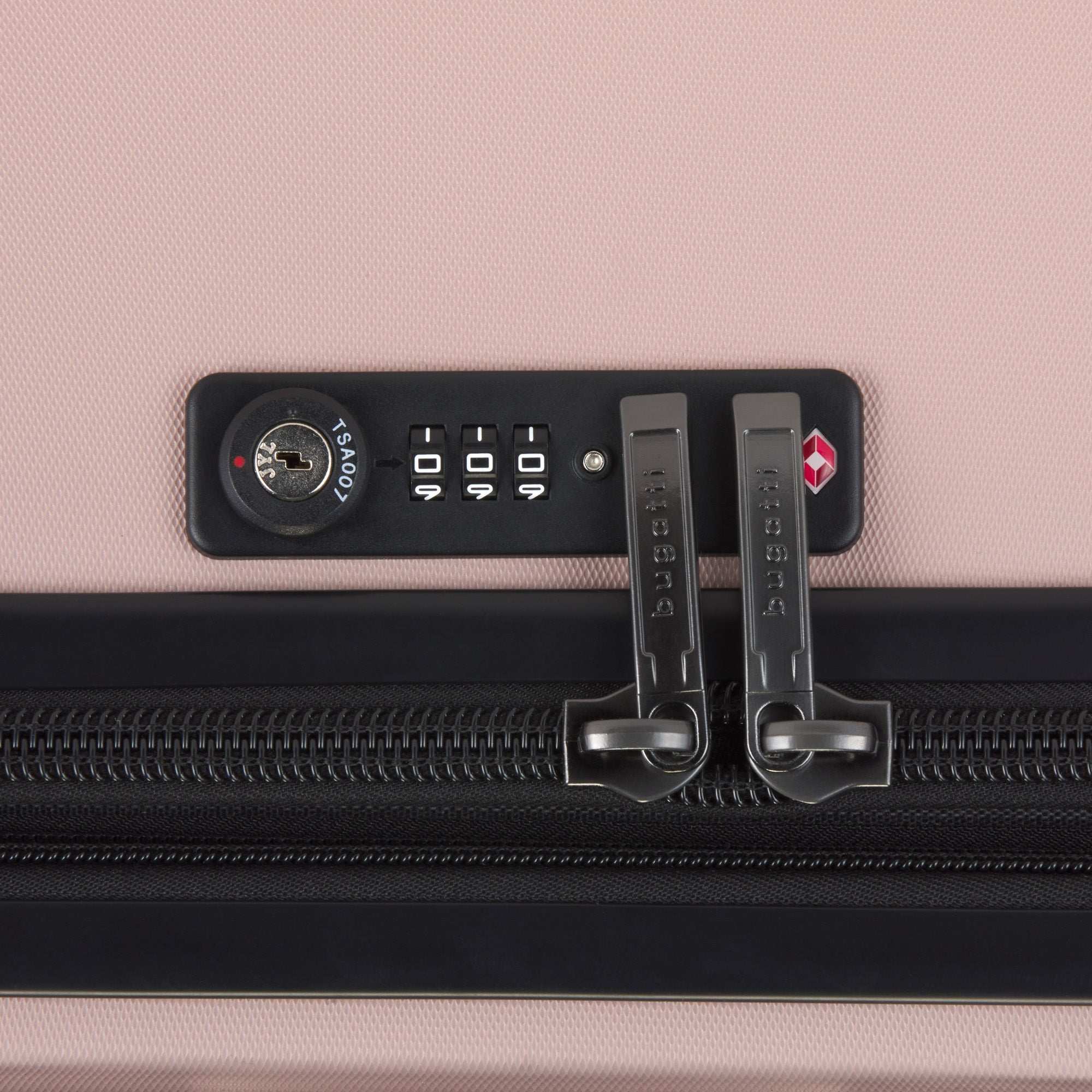 Close-up of a suitcase with a combination lock on a pink background