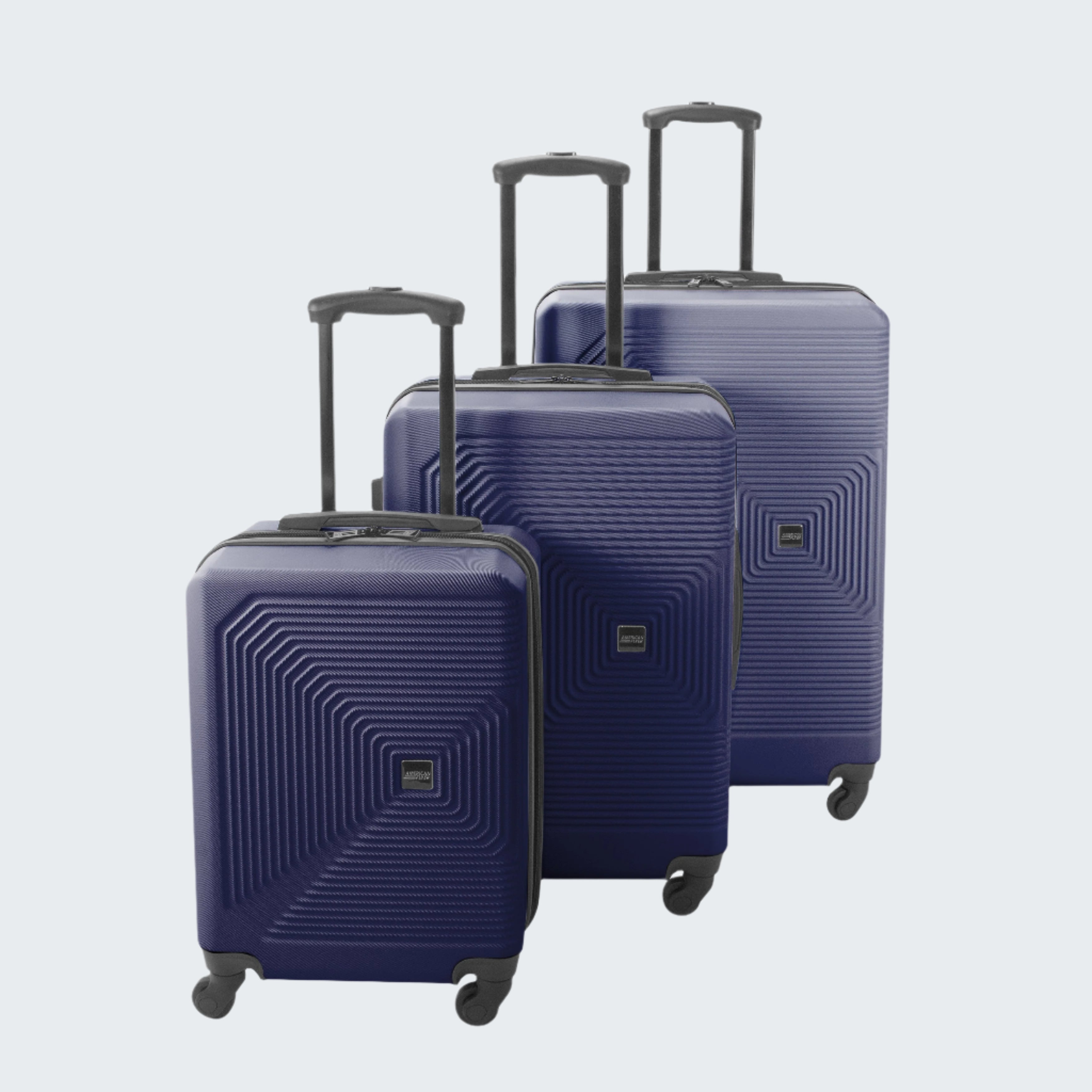 Set of three blue suitcases with geometric patterns on a white background
