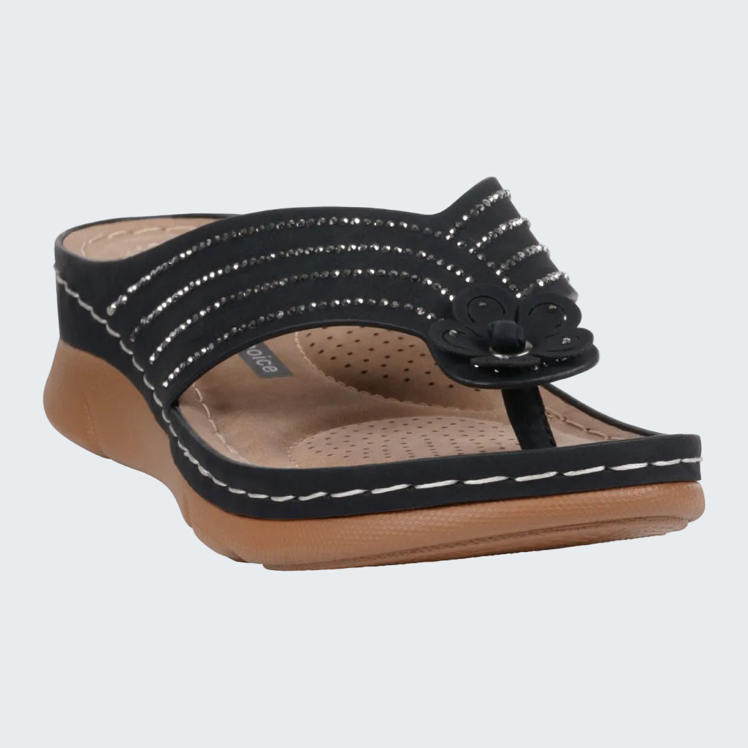 Black sandal with brown sole on a white background