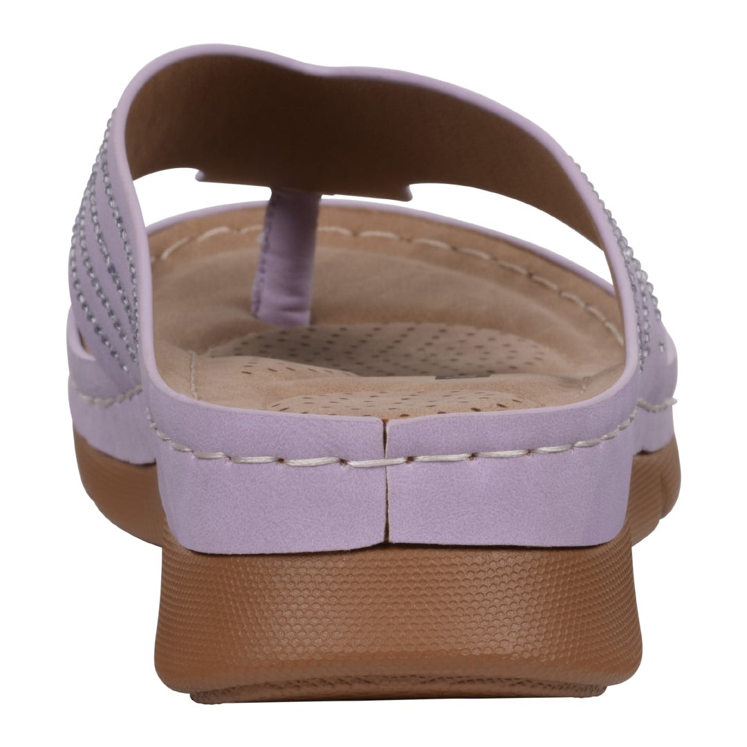 White sandal with brown sole on a white background