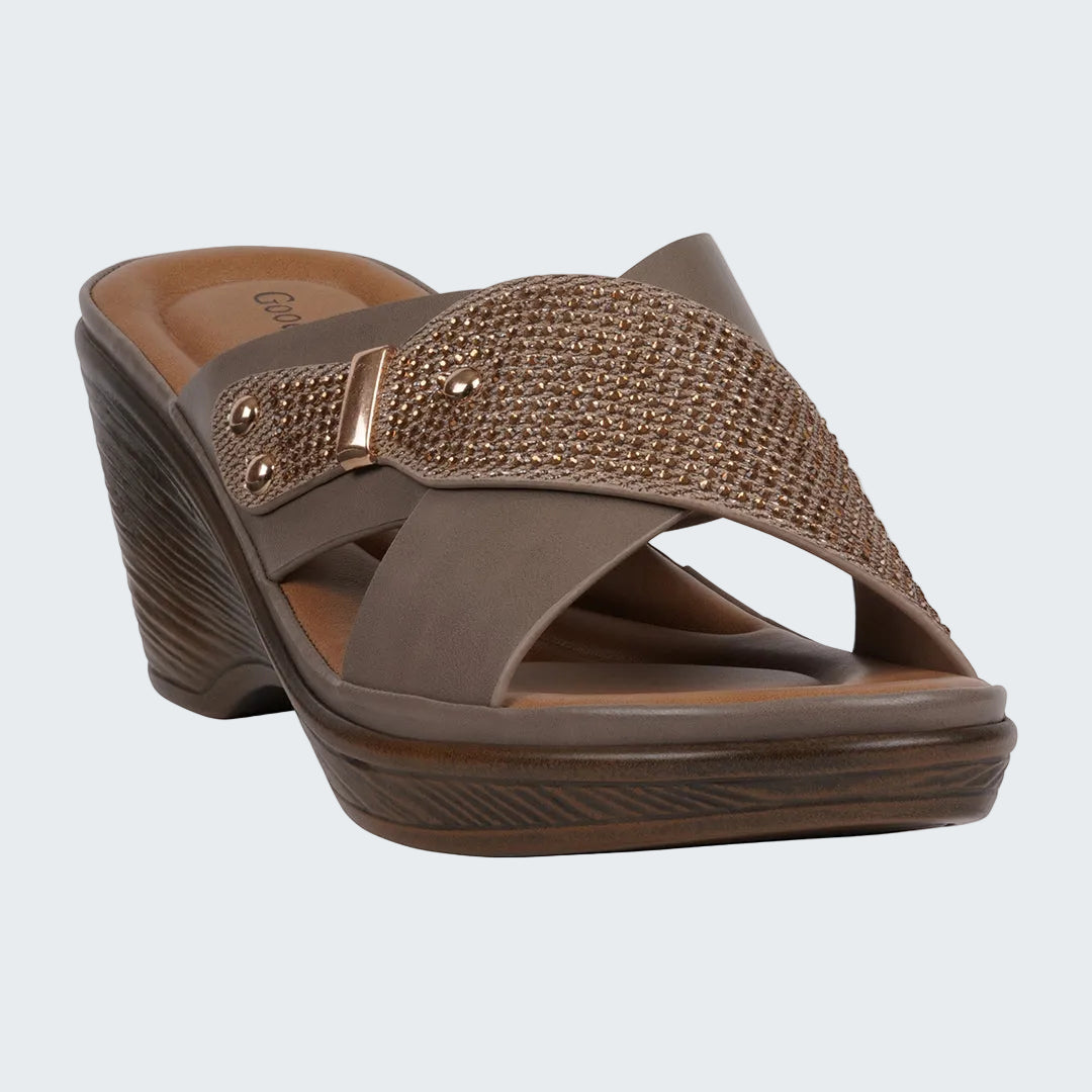 Brown sandal with a decorative strap on a white background