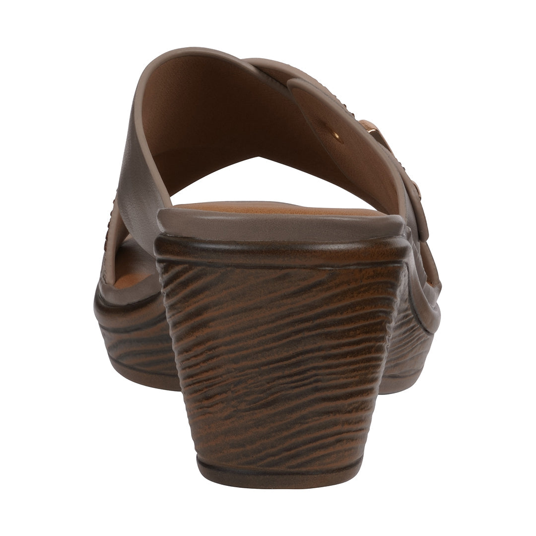 Brown sandal with a textured sole on a white background