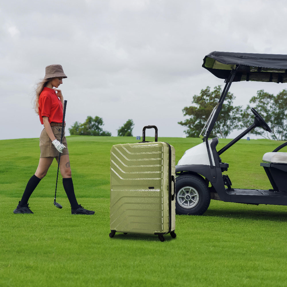 Woman with a suitcase on a golf course next to a golf cart