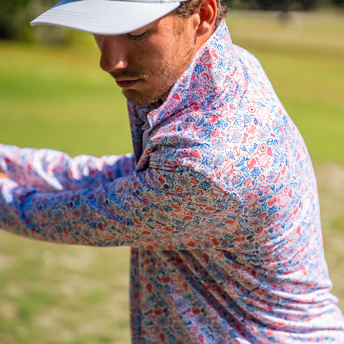 Man in a colorful shirt and cap on a golf course