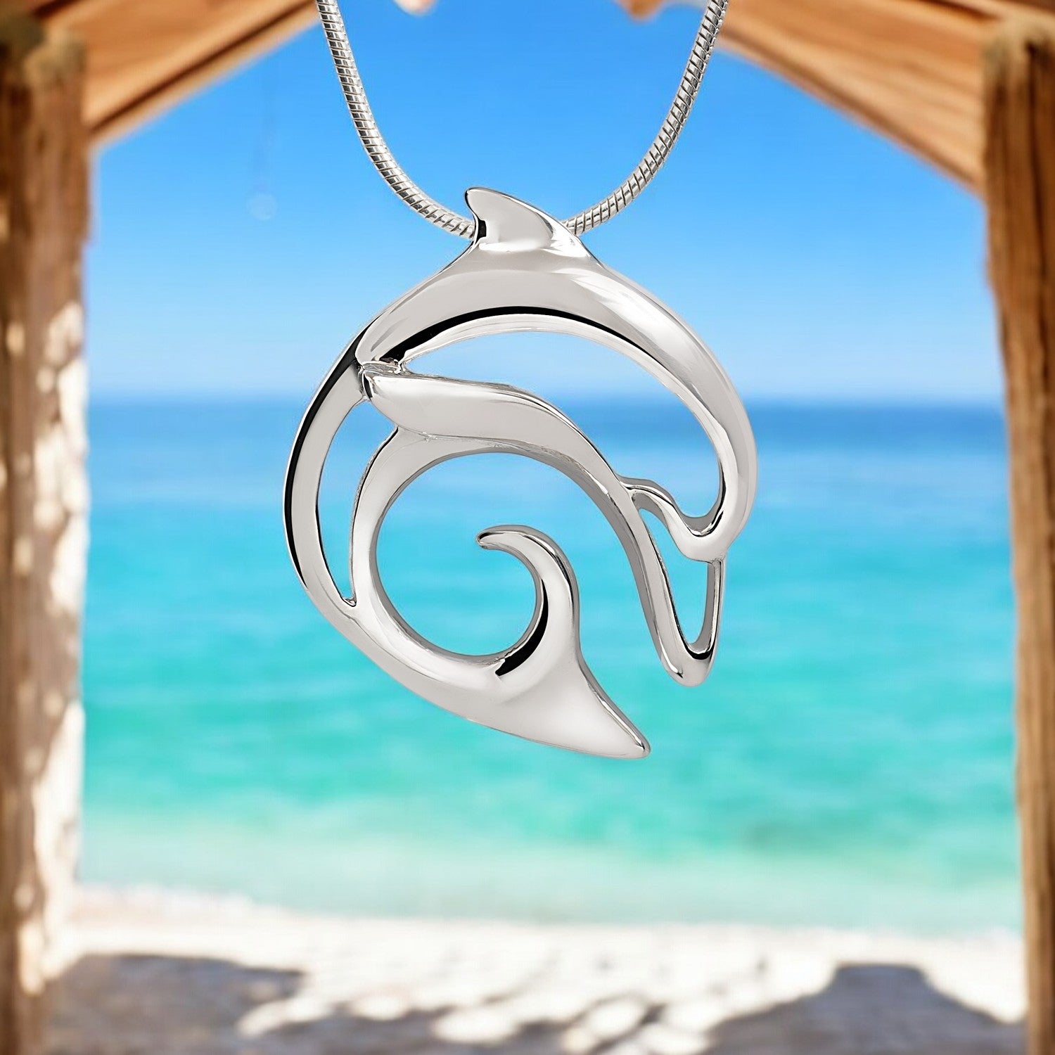 Silver wave pendant necklace with a beach and ocean background