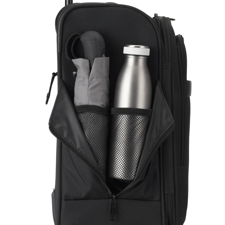 Black backpack with a silver water bottle and gray pouches inside on a white background