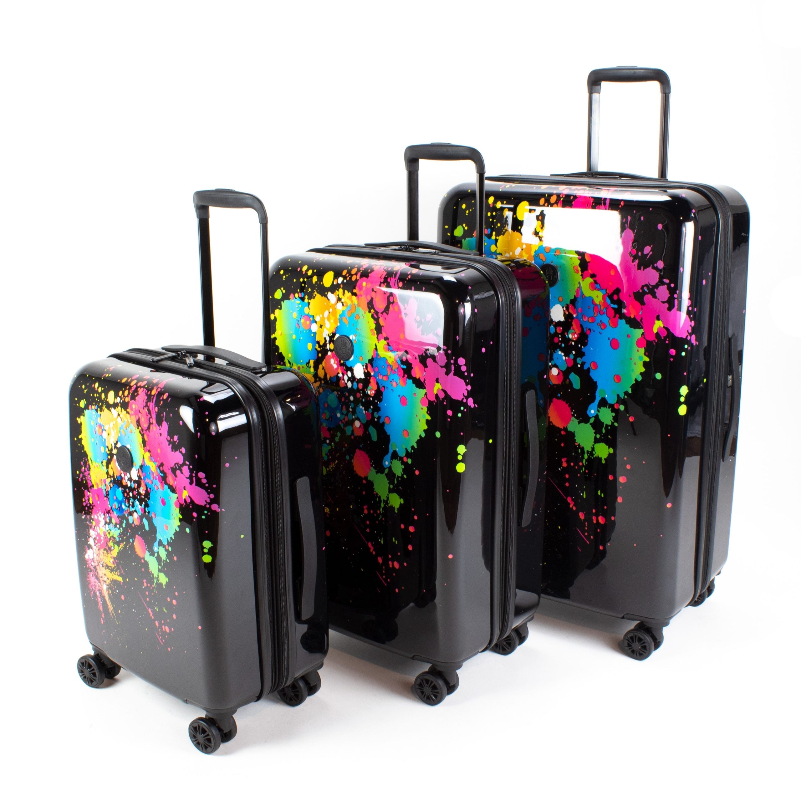 Set of three black suitcases with colorful splatter designs on a white background