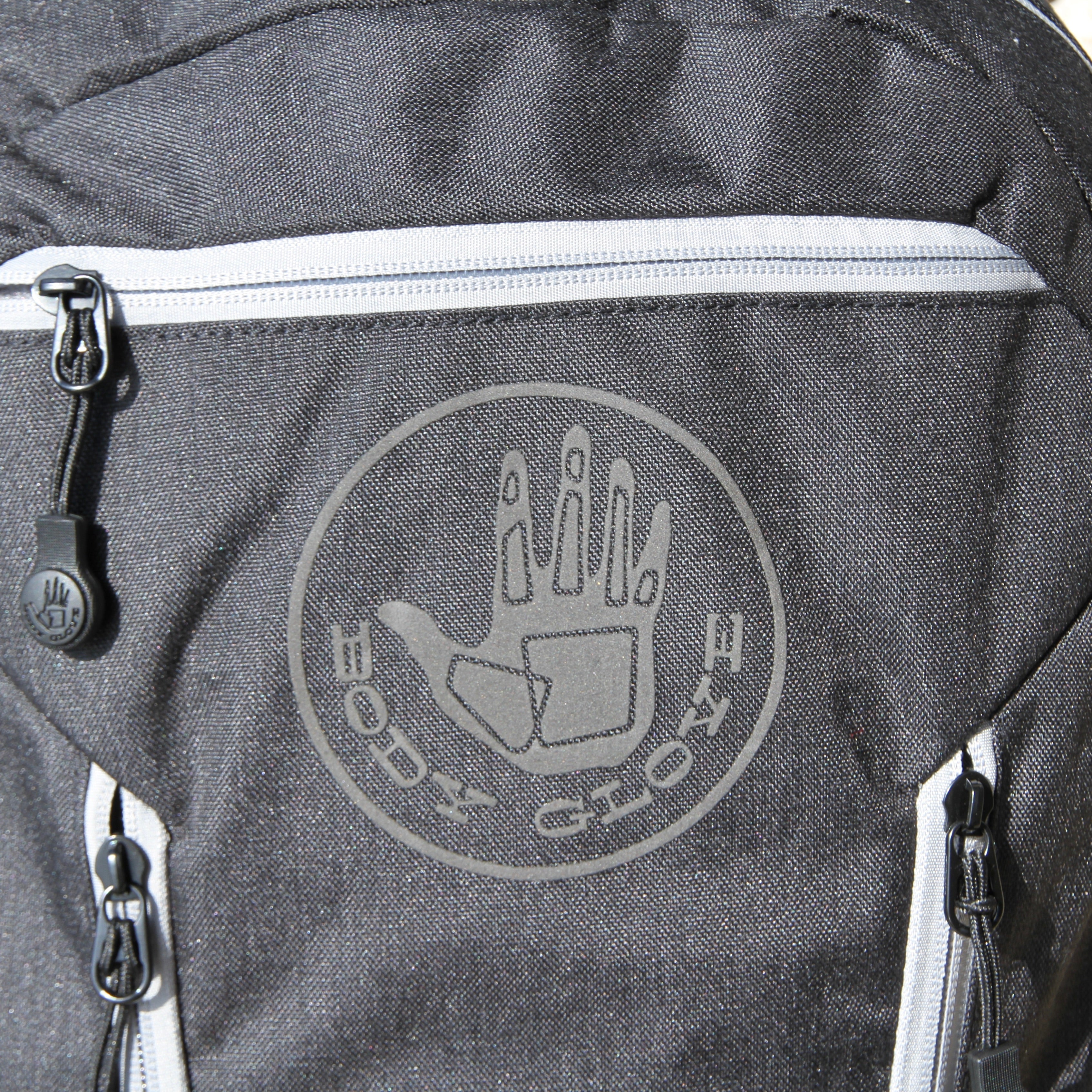 Gray backpack with a logo on the back