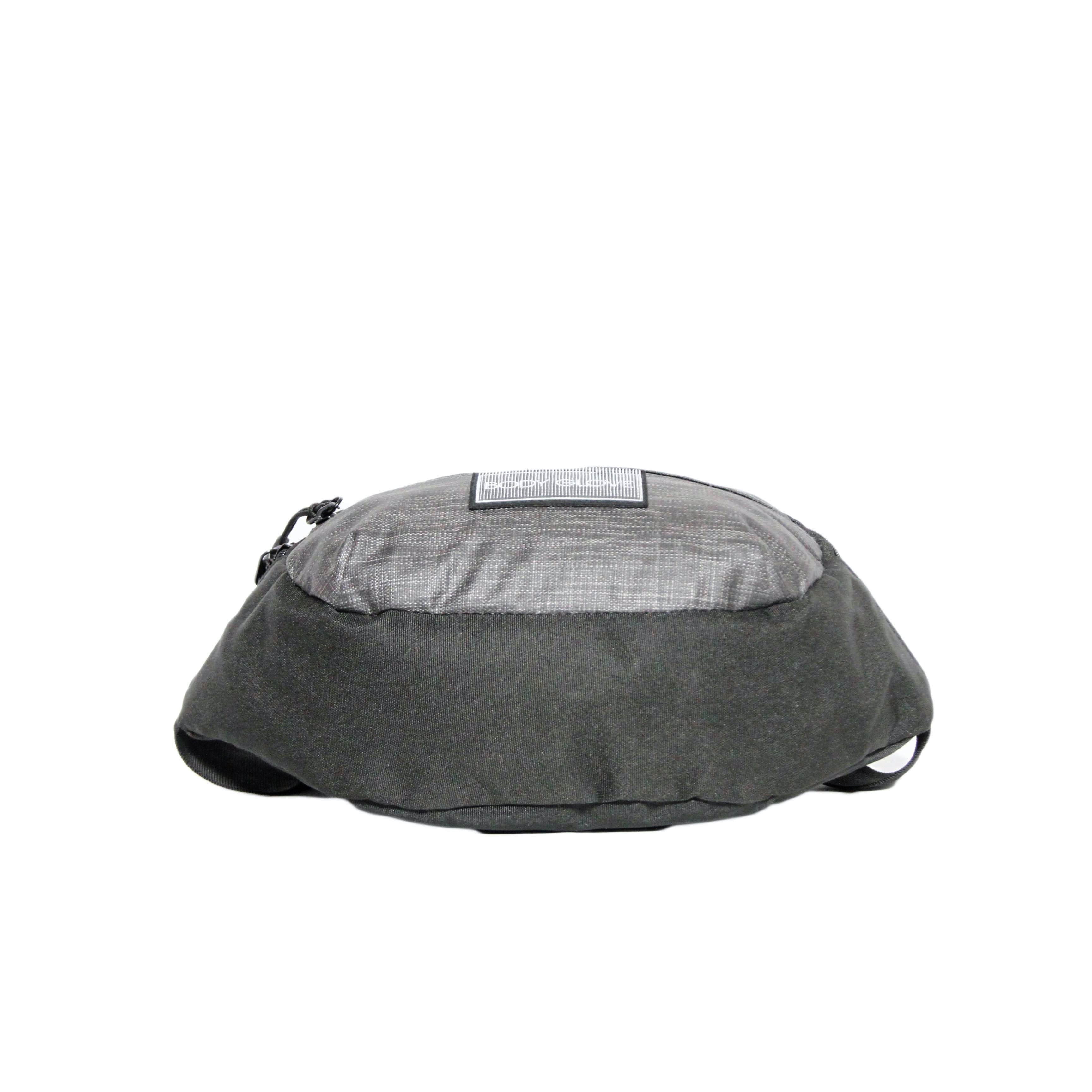 Gray dog bed with a textured surface on a white background