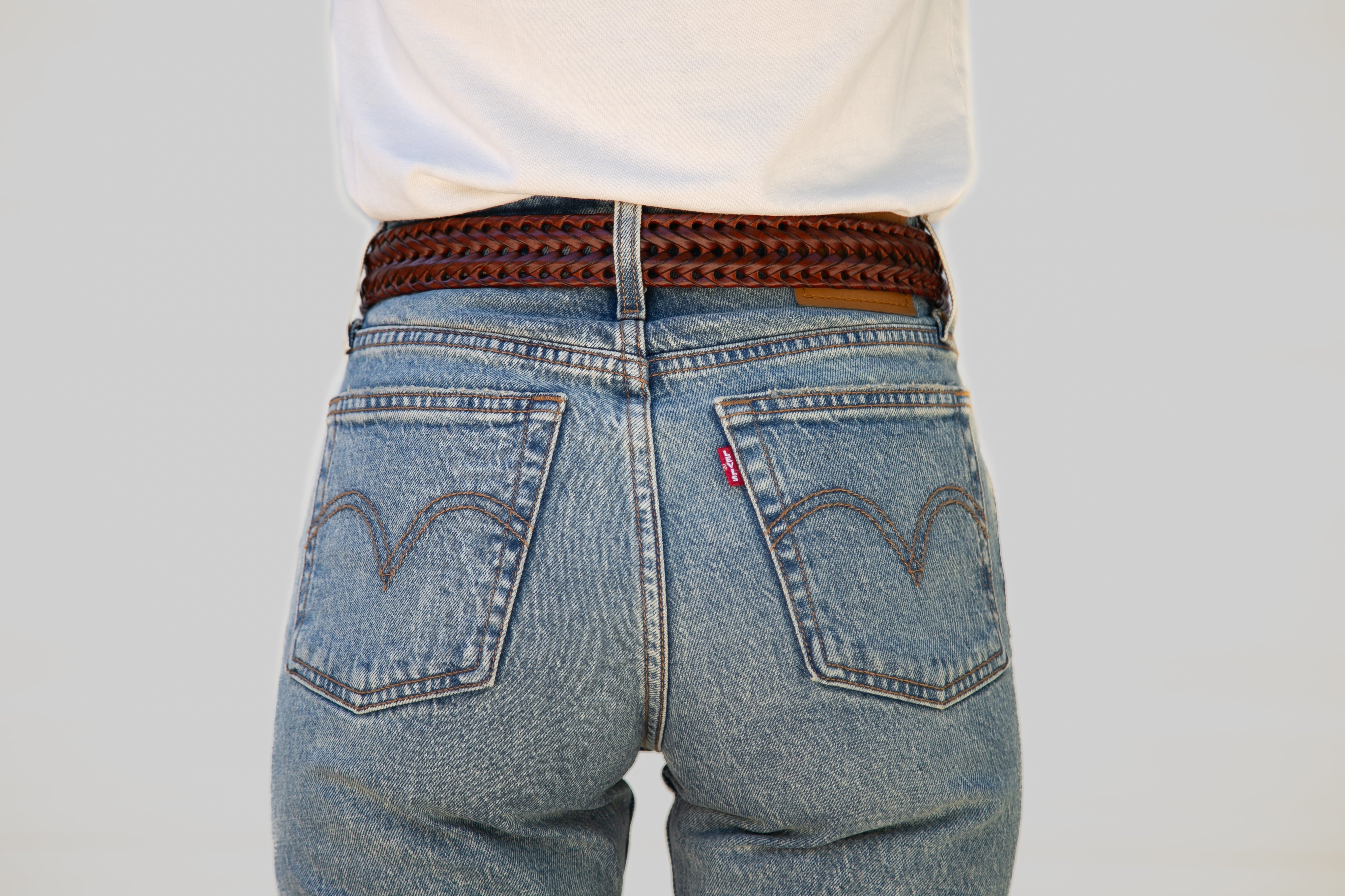 Blue jeans with a Levi's logo on a plain background