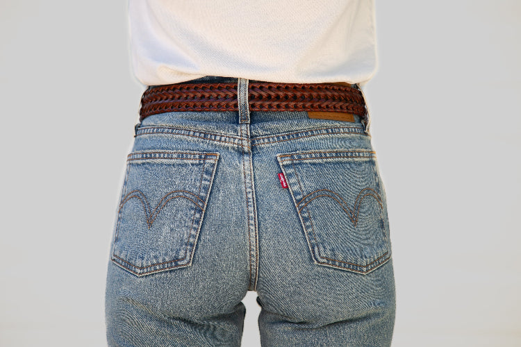 Blue jeans with a Levi's logo on a plain background