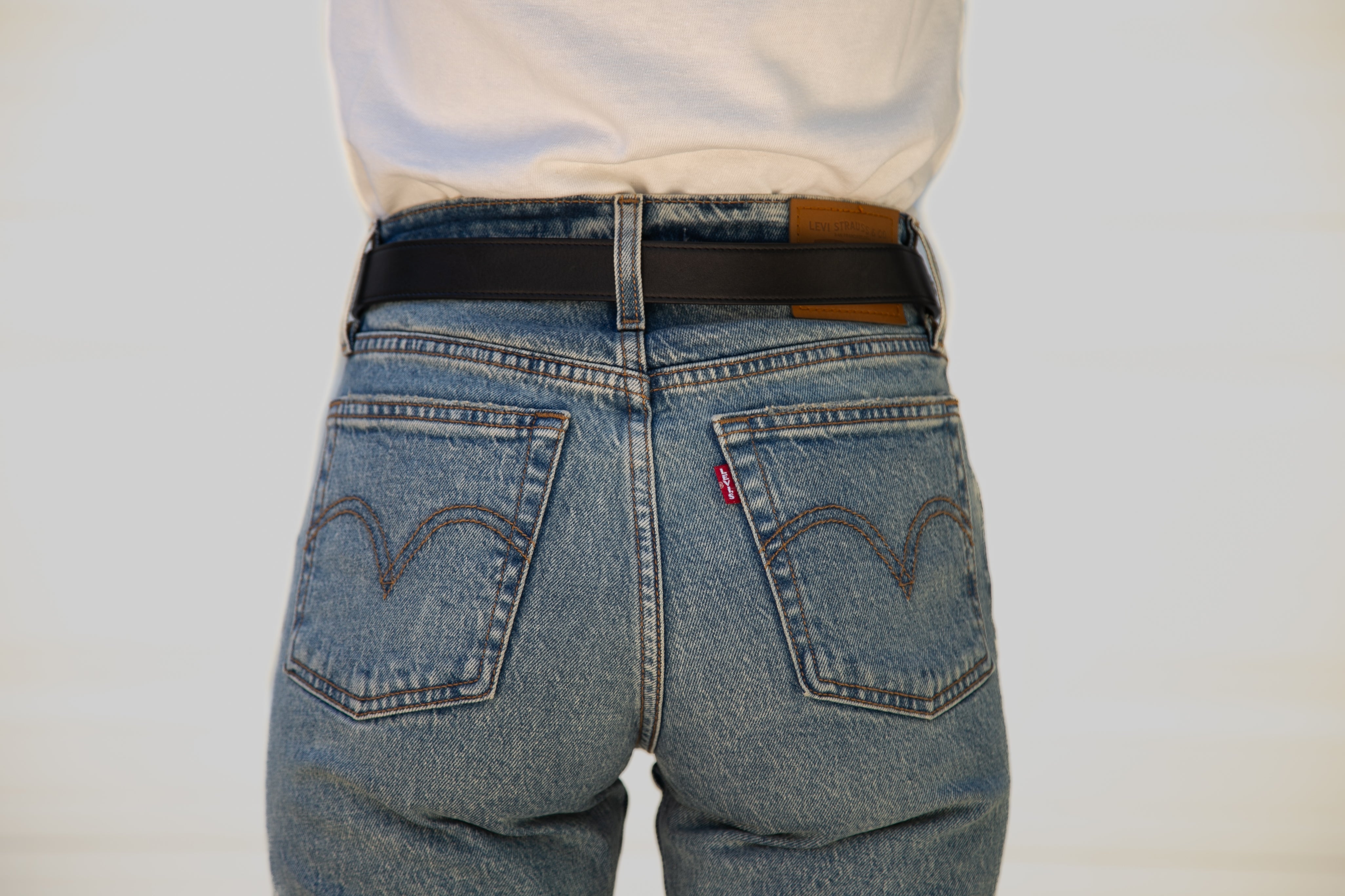 Back view of blue jeans with Levi's logo on a white background