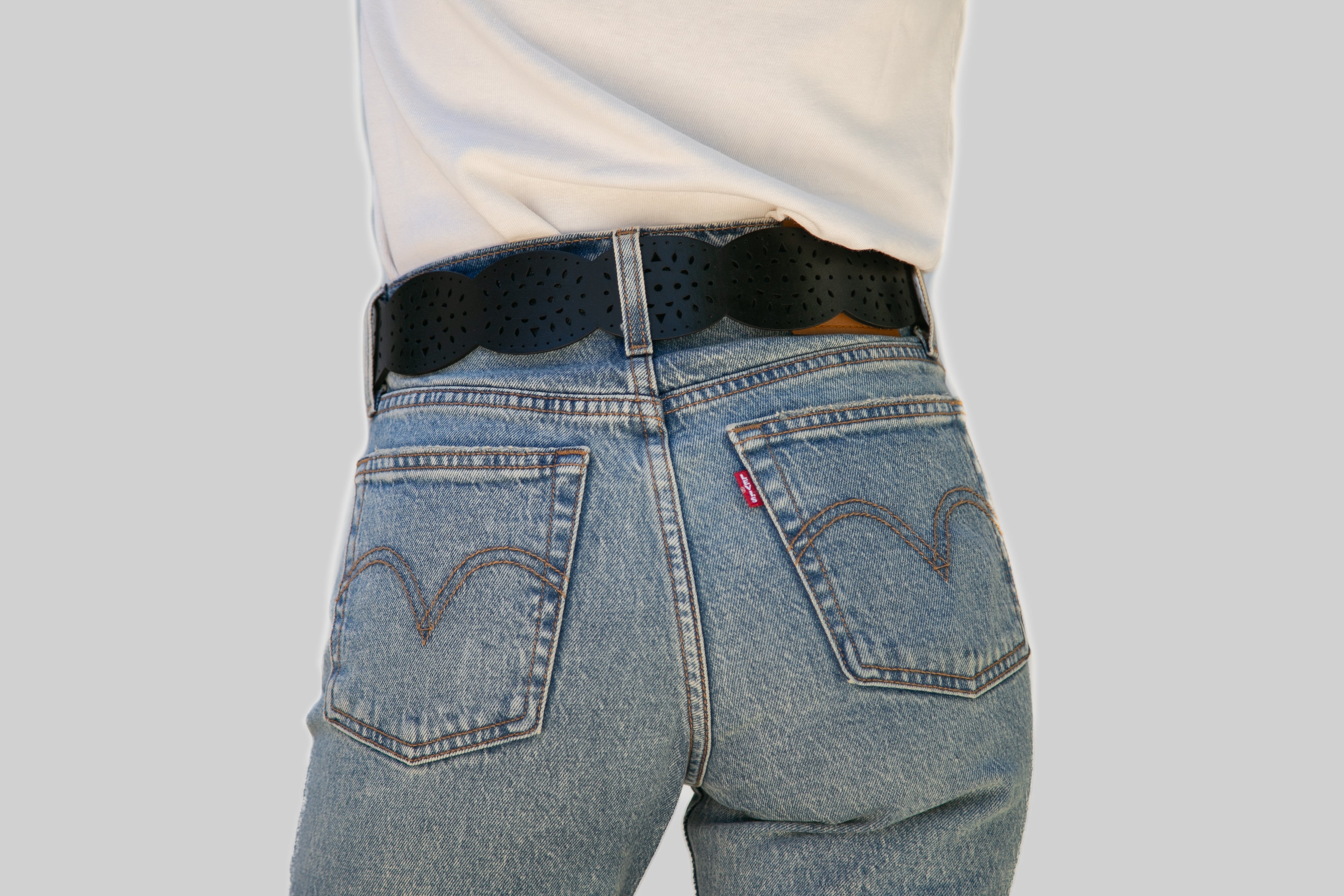 Blue jeans with a Levi's logo on a plain background