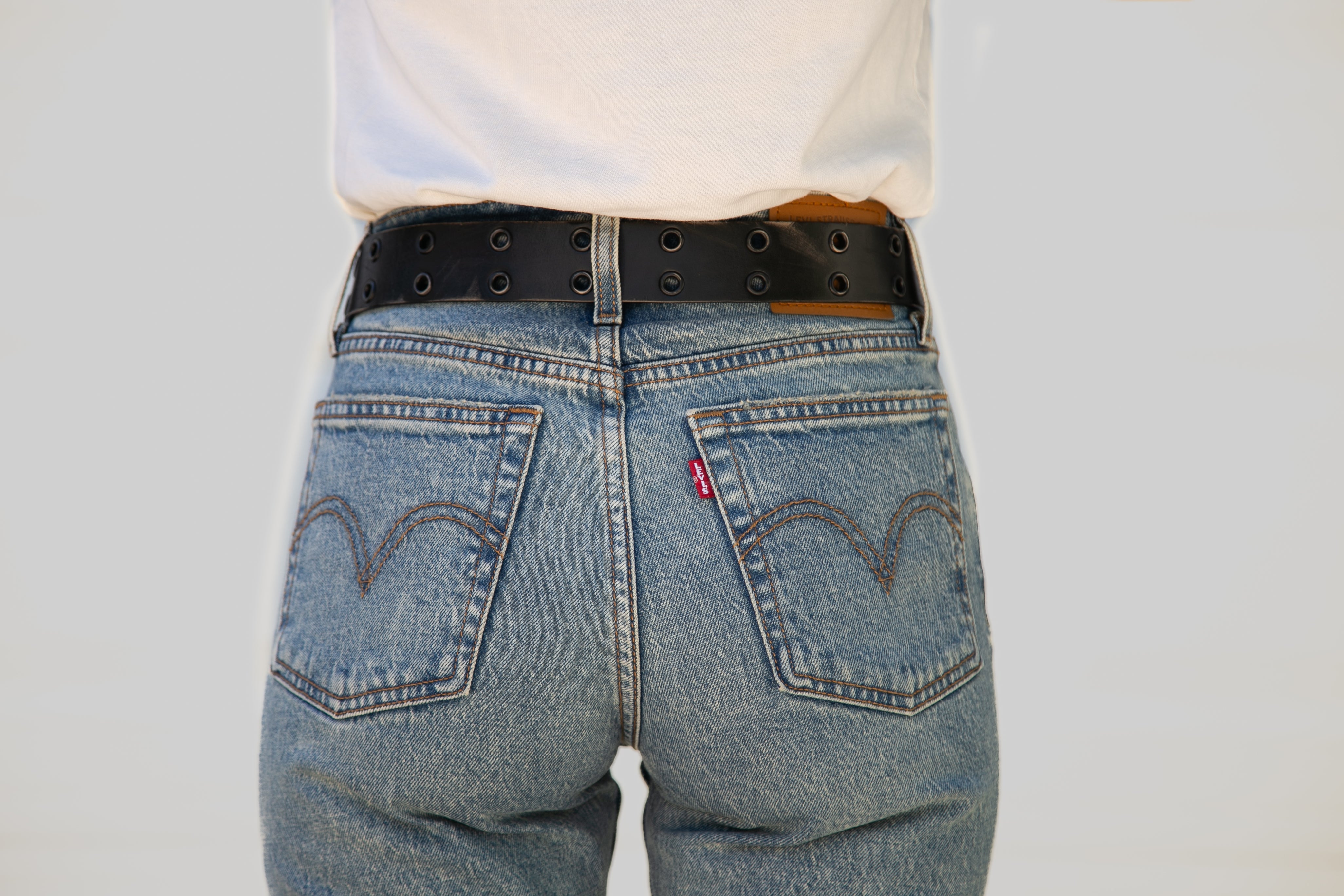 Blue jeans with a Levi's logo on a plain background