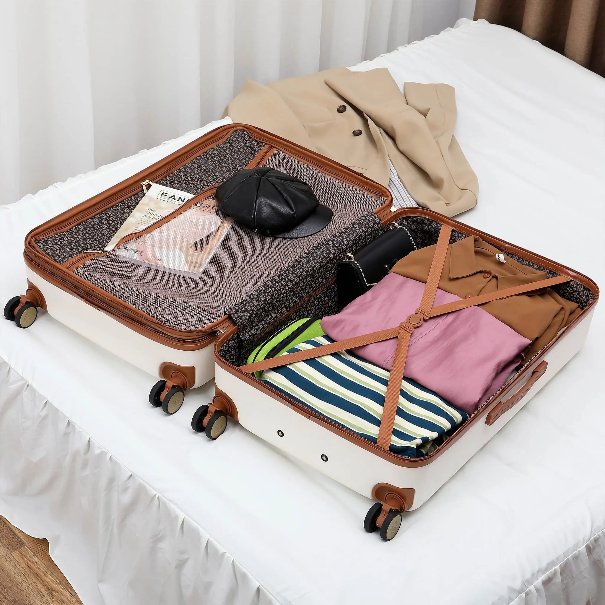 Open suitcase on a bed with clothes and a cap inside