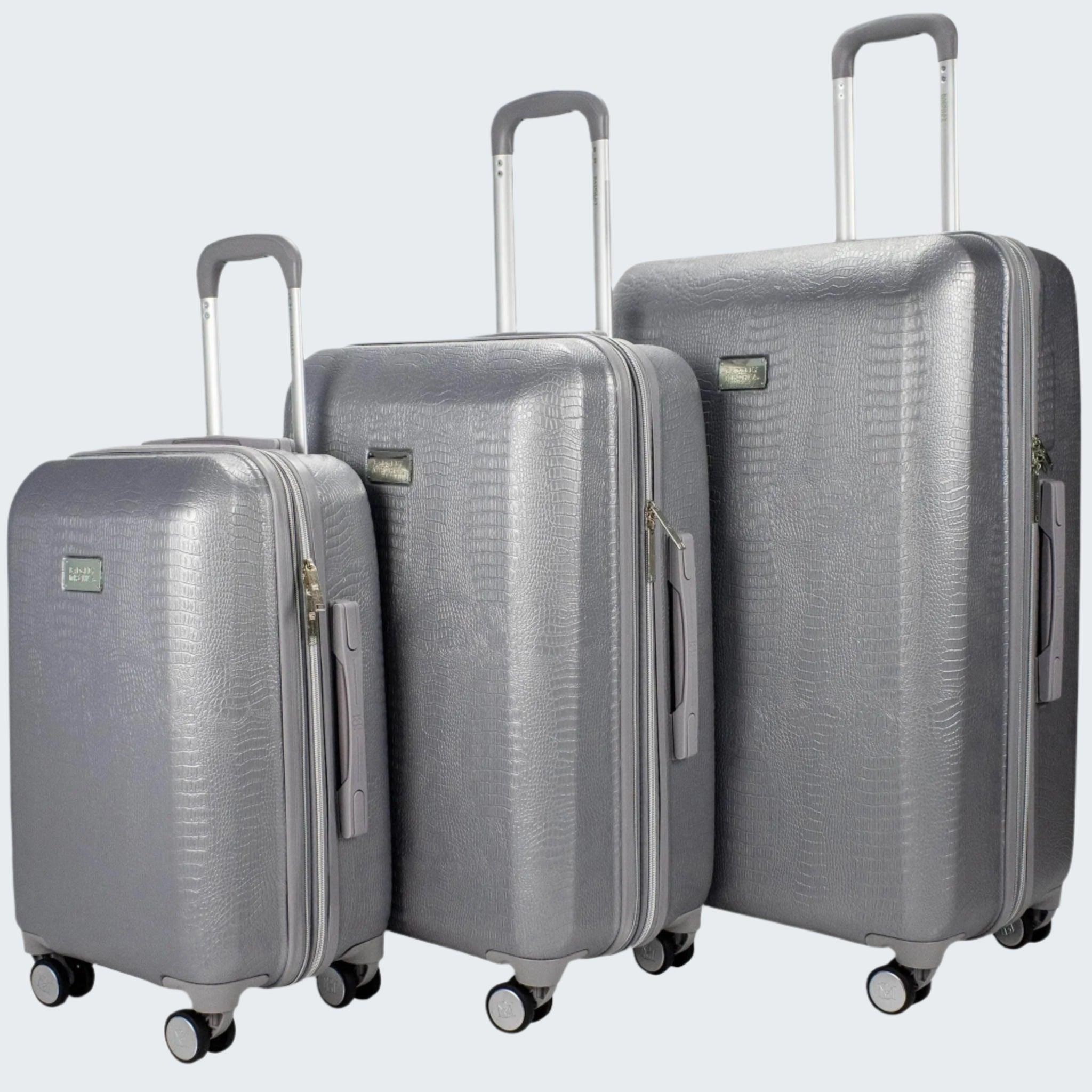 Set of three gray suitcases of different sizes on a white background
