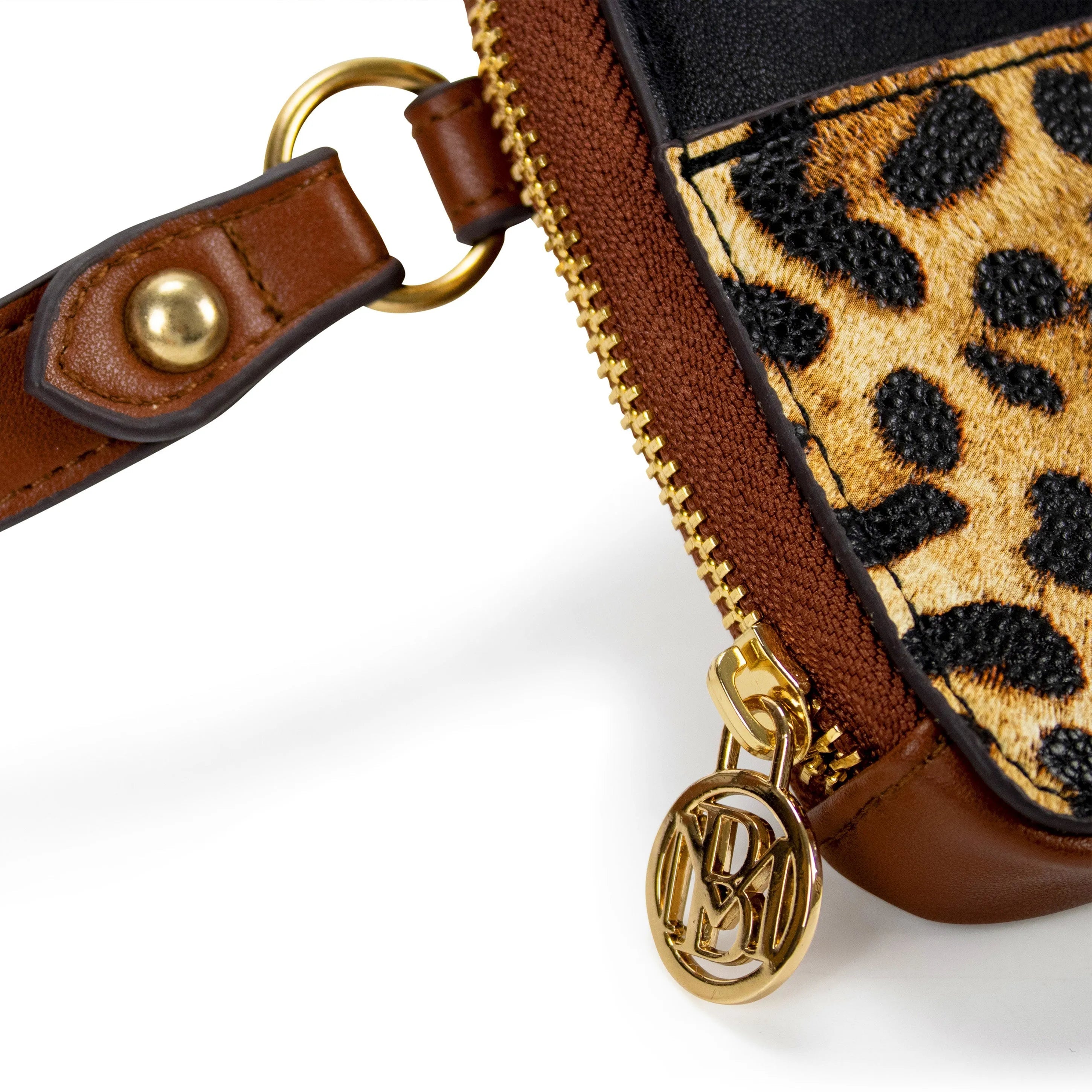 Close-up of a brown leather bag with gold zipper and leopard print detail on a white background
